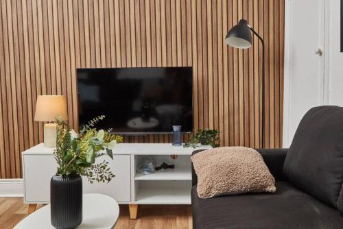 a living room with a couch and a large television at 4 bedroom, 6 beds, 10 guest, Free parking on site in Elswick