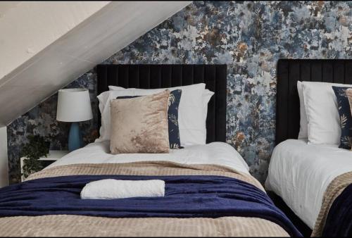 a bedroom with a large bed with a blue blanket at 4 bedroom, 6 beds, 10 guest, Free parking on site in Elswick