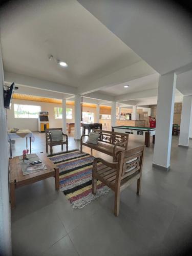 a living room with a couch and a table at Leviv Praia Hotel in Caraguatatuba