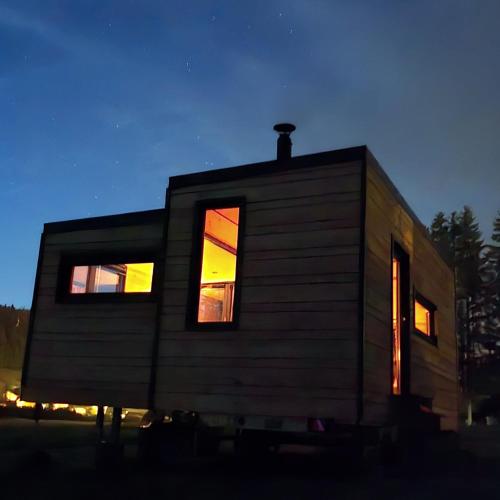 a tiny house with two windows on the side at La cachette du Jura in Bois-dʼAmont