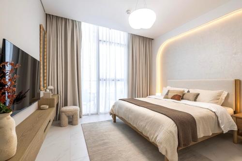 a bedroom with a large bed and a large window at District One Dubai Lagoon View Near Downtown in Dubai