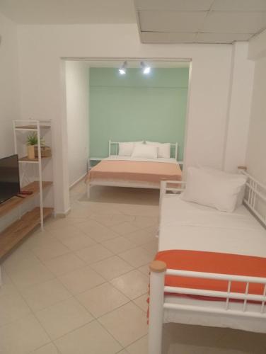 a room with two beds and a television in it at Kavala Hotel Bodrum in Bodrum City