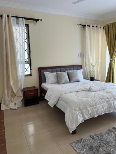 a bedroom with two beds and a window at MoDi's Seaside Nest in Mombasa