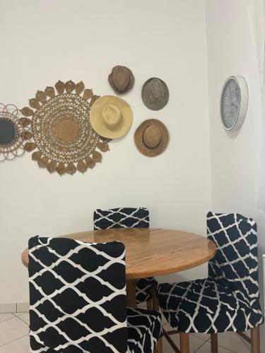 a dining room with a table and some hats on the wall at Beach House Avlakia in Samos