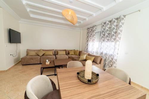 a living room with a couch and a table at Appartement Dar Tamraght in Tamraght Ouzdar