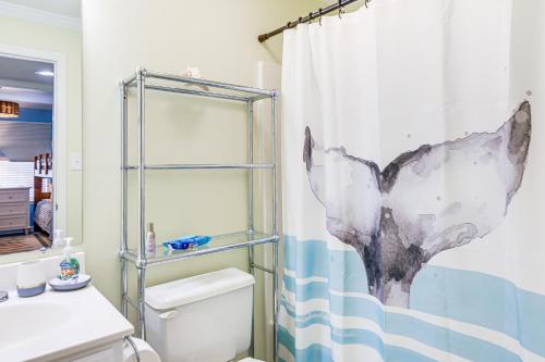 a bathroom with a shower curtain and a toilet at Marina Views, Walk to Beach Atlantic Beach Condo! in Atlantic Beach