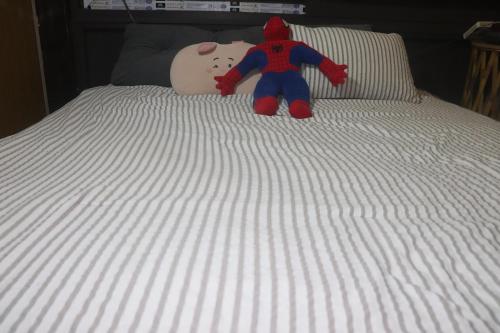 a teddy bear sitting on top of a bed at Atash Eco Village Homestay Van Hoi in Quân Khê