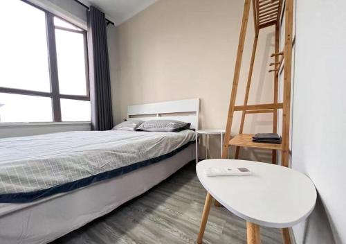 a bedroom with a bed and a ladder and a chair at Huainan Aisen Homestay Two Bedroom Apartment with Kitchen Elevator and Parking in Huainan
