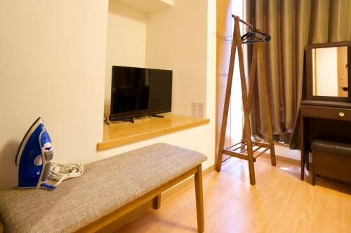 a living room with a flat screen tv and a couch at Ueno Hoshi-5 minutes from Iriya Station-1 stop from Ueno station in Tokyo