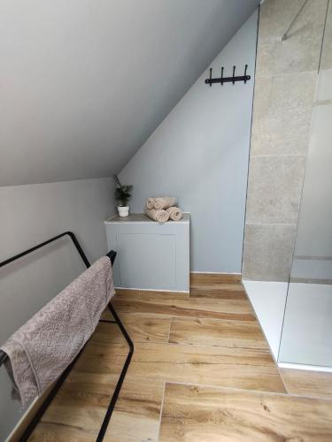 a attic room with a bed and a shower at BAN CHAILAI studio in Marckolsheim
