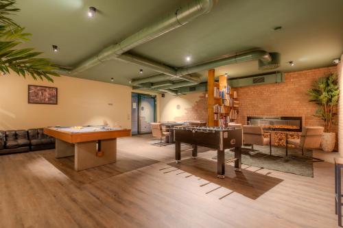 a living room with a pool table and ping pong tables at Hannover - PHIL & MAX Hotels und Apartments Messe in Hannover