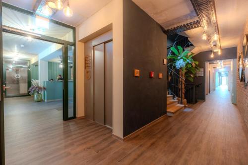 a hallway in an office building with a hallway leading into a room at Hannover - PHIL & MAX Hotels und Apartments Messe in Hannover