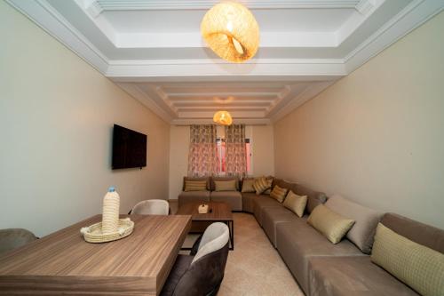 a living room with a couch and a table at Appartement Dar Tamraght in Tamraght Ouzdar