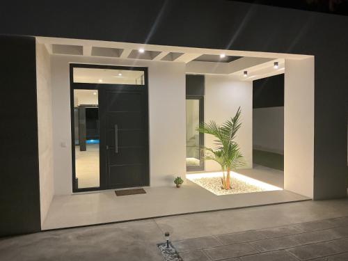 a room with a black door and a plant in it at Esmeralda Sea Villa - Beach&Golf Sancti Petri in Novo Sancti Petri