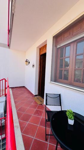 a patio with a table and chairs and a window at Kasa Mondello in Mondello