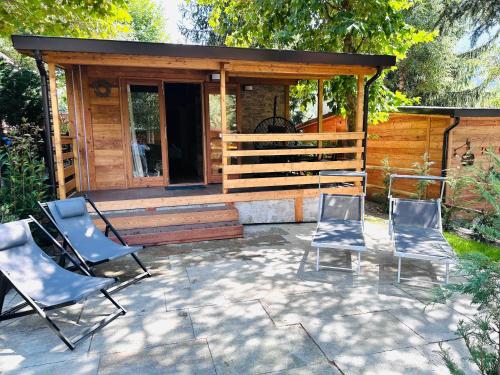 a group of chairs sitting in front of a cabin at Bijoux Des Alpes - Mont Blanc Village in La Salle