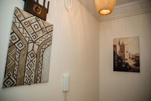 two pieces of art hanging on a wall at Appartement Dar Tamraght in Tamraght Ouzdar