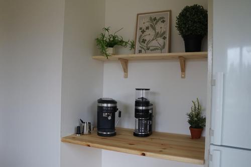a coffee maker on a wooden shelf in a kitchen at Renovated Lake view Retreat with Kayaks & Big Garden in Klavreström