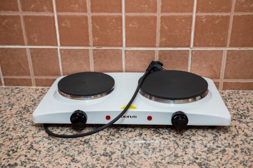 a white stove with two burners on a counter at Appartement Dar Tamraght in Tamraght Ouzdar