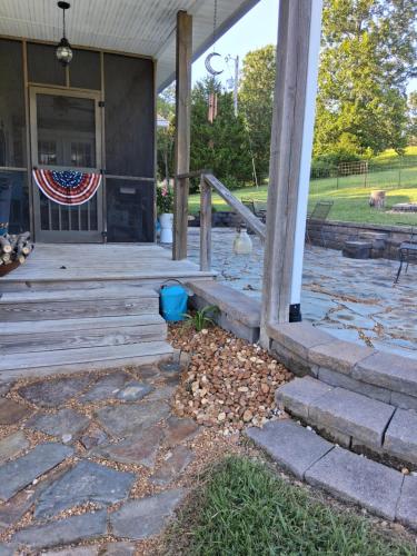 a porch with an american flag on a house at Flatt Creek Cottage in Livingston