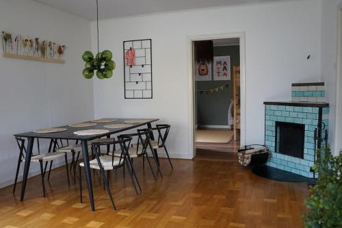 a dining room with a table and chairs and a fireplace at Renovated Lake view Retreat with Kayaks & Big Garden in Klavreström
