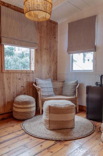 a living room with a couch and chairs and a table at Stoep By Ideas Cartel in Kalk Bay