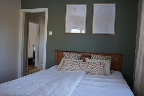 a bed with white sheets and pillows in a bedroom at Renovated Lake view Retreat with Kayaks & Big Garden in Klavreström