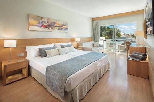 a bedroom with a large bed and a balcony at Maspalomas Princess in Maspalomas