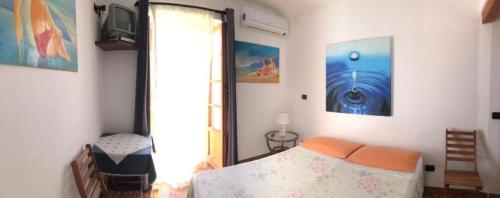 a bedroom with a bed and a sliding glass door at La Luna di Botto Bruce in Chiavari