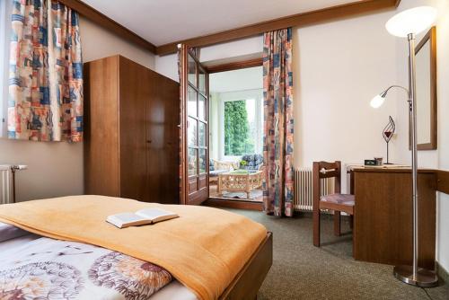 a bedroom with a large bed with a desk and a desk at Appartement Haus Drobollach in Drobollach am Faakersee