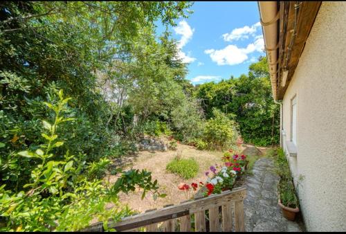 a view of a garden with flowers on a balcony at Cosy house in Saint-Aunès