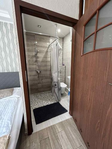 a bathroom with a shower and a toilet in it at Zajazd Primavera in Kraśnik
