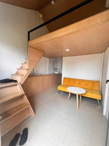a room with a bench and a table and stairs at KoMleo Farm in Buôn Kô M'lêo