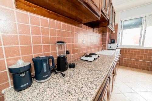 a kitchen with a counter with appliances on it at Appartement Dar Tamraght in Tamraght Ouzdar