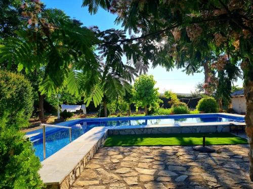 a swimming pool in a yard with a tree at Torreon de Nubla in Cazorla