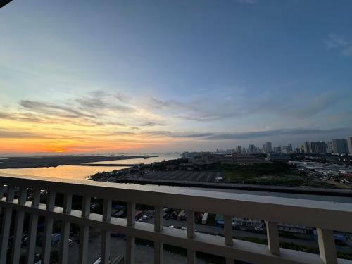 a view of a sunset from a balcony of a city at Seaside Manila Bay Sunset View at SM Mall of Asia in Manila
