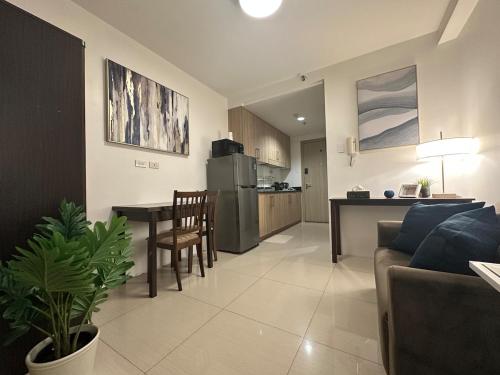 a living room and kitchen with a couch and a table at Seaside Manila Bay Sunset View at SM Mall of Asia in Manila