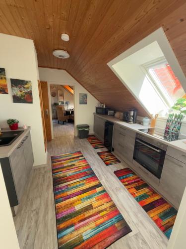 a kitchen with a large colorful rug on the floor at Am Wäldchen in Hechthausen