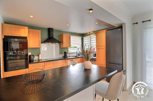 a kitchen with a black counter top in a room at Les acacias in Lamballe Armor
