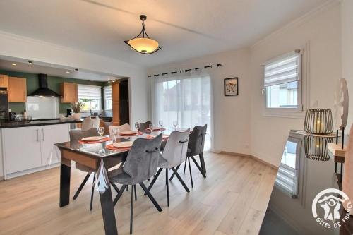 a dining room and kitchen with a table and chairs at Les acacias in Lamballe Armor