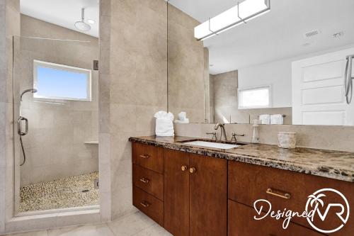 a bathroom with a sink and a shower at 7 BR Intercostal Beauty with Heated Pool in Hallandale Beach