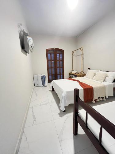 Una cama o camas en una habitación de Pousada Lisamar