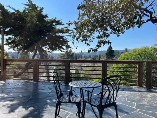 a table and two chairs on a patio at The Midtown Cottage- w/ Private Entrance and Views in Santa Cruz