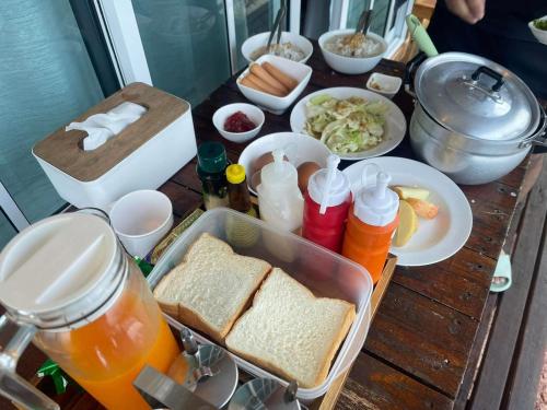a table with sandwiches and other food on it at Baan Klangkao - บ้านกลางเขา สะปัน in Ban Huai Ti