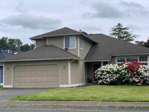 a brown house with a garage at Cedar River 1 BR in 4 BR HOUSE in Renton