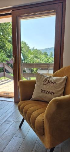 a couch sitting in front of a door with a window at dziupla in Górki Wielkie