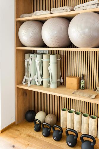 a shelf filled with white bowls and other dishes at Boutique Aparthotel Chalets Coburg in Schladming