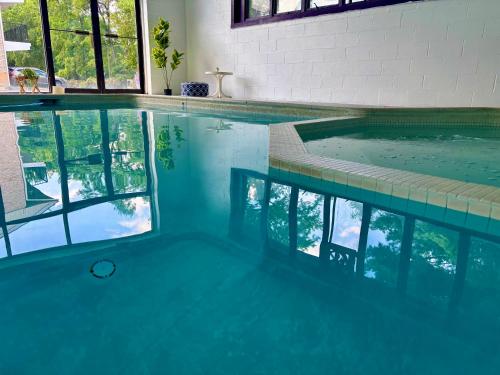 a swimming pool with blue water in a building at APM Inn and Suites in Winchester
