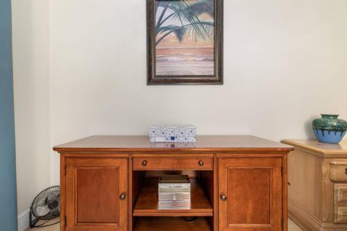 a wooden cabinet in a room with a picture on the wall at New Port Richey Downtown Delight! in New Port Richey