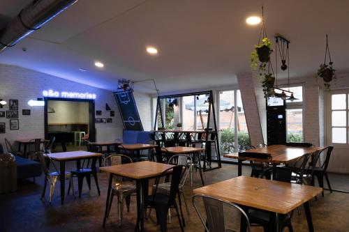 a restaurant with tables and chairs in a room at a&o Berlin Friedrichshain in Berlin